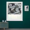Floral Roman blind, gray-and-white blooms, lowered over the upper sash, softly filtering daylight; in a room with deep teal walls, white trim, small dresser and a framed abstract print.
