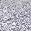 Folded fabric with purple background and white hand-drawn diagonal stripe hexagon pattern; the cloth is folded once with a visible overlap; close-up on a flat surface under even studio lighting.