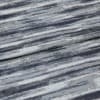 Folded jacquard curtain fabric with horizontal blue-gray, navy, and white striations; draped over itself, revealing woven texture and subtle sheen in a close-up, softly lit studio view.