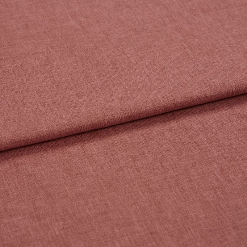 Dusty-rose woven fabric (linen-like), folded once forming a horizontal overlap; textured weave visible, shown in soft diffuse lighting as a close-up flat lay on a neutral surface.