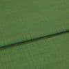 Green woven fabric panel, folded across the frame creating a horizontal ridge; fine textured weave visible, close-up with soft even lighting and neutral background.