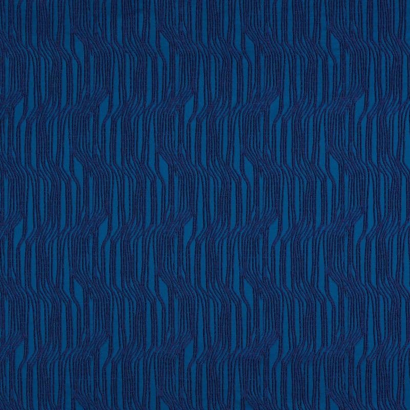 Textured blue wallpaper with raised, wavy vertical navy ribbed stripes forming repeating undulating columns; close-up, evenly lit flat surface with no visible surroundings.