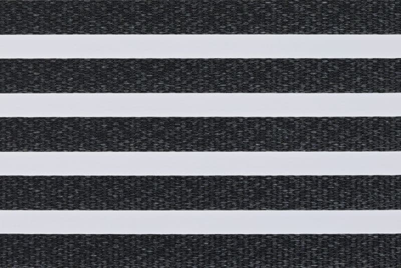 Zebra-style roller blind: alternating opaque white and textured charcoal-gray woven horizontal bands filling the frame; bands aligned to block or filter light in a close-up interior view.
