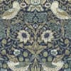 Stylized birds perched on curling vines, facing inward among large sunflowers and strawberries; ornate floral foliage repeats symmetrically across a muted navy, green and beige decorative wallpaper pattern.