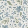 Blue watercolor-style flowers and green leaves repeat across a textured off-white fabric background, forming a scattered, overlapping floral pattern with delicate brushstroke detailing.