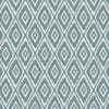 Geometric fabric or wallpaper with teal, stepped diamond motifs arranged in a regular repeating lattice, covering the surface; functioning as decorative wall or upholstery covering in a well-lit interior.