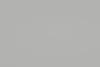 Uniform light-gray wall (object) covering the entire frame and appearing featureless and matte (action); diffuse even lighting with no discernible fixtures, shadows, or room context (context).