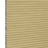 Honeycomb (cellular) blind, tan with silver inner cells, fully lowered and closed, filtering and blocking light; close-up view showing horizontal pleats and cell edges against a neutral interior background.