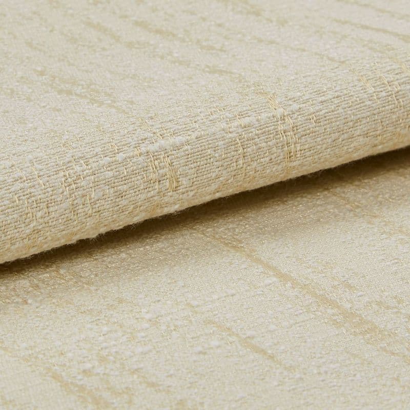 Beige woven fabric with a subtle raised grid and slight sheen, folded and layered across the frame, shown in a close-up, softly lit studio view emphasizing texture and threads.