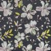 Dark charcoal textile featuring embroidered pastel floral motifs—large, sketchy blossoms and leaves—repeating across the surface, creating a soft, vintage botanical pattern in muted pinks, greens, and yellow.