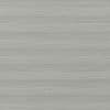 Gray fabric window shade with fine horizontal striations, closed, softly diffusing light in a neutral, softly lit interior close-up.