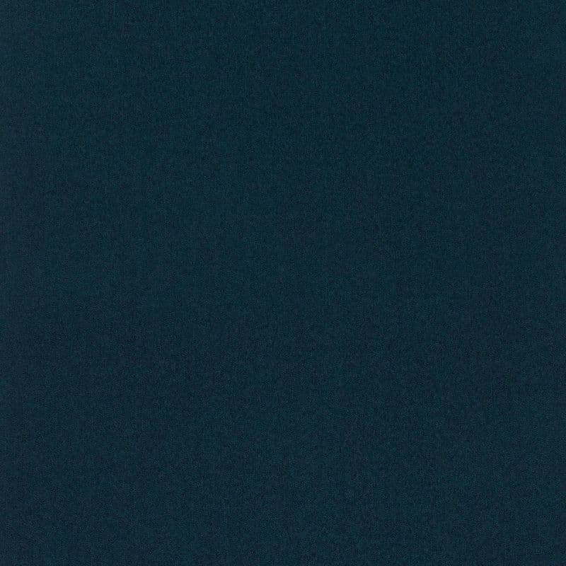 Dark teal, finely speckled surface fills the frame, uniformly lit and featureless, resembling low-light digital noise or coarse fabric.