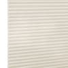 Off-white cellular (honeycomb) shade with evenly spaced horizontal pleats, lowered and closed, filtering soft light; textured linen-like fabric visible against a neutral bright background with no room details.