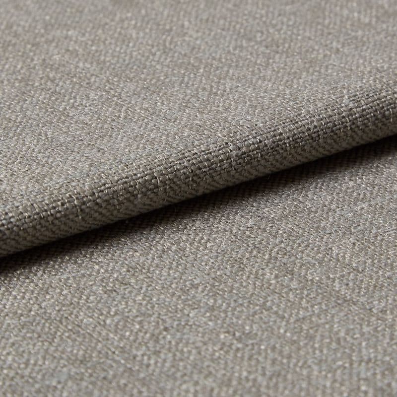Beige woven fabric folded over itself, showing a tight basket-weave texture; lying flat in soft, neutral lighting, close-up view emphasizing threads and subtle sheen.