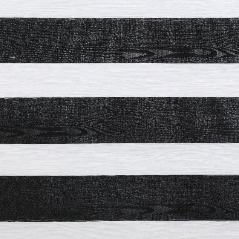 Horizontal zebra roller blind with alternating wide black wood-grain textured and white translucent bands; bands partially filter light, shown in a close-up indoor view with neutral, even lighting.