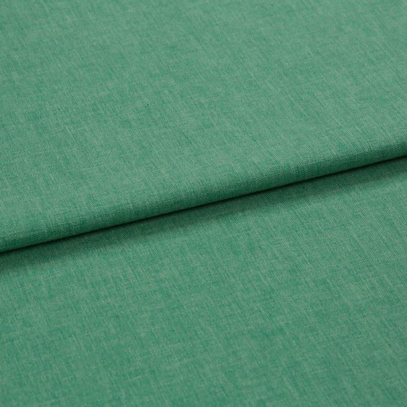 Green woven fabric folded over itself, forming a horizontal overlap; close-up studio view with even lighting and a subtle heathered texture.