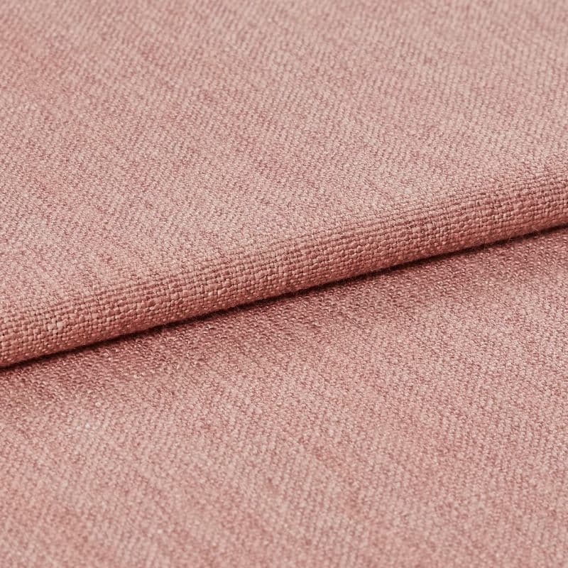 Pink woven upholstery fabric, tightly woven with visible grain and a folded edge, lying stacked; fabric displays subtle sheen and fine texture in a soft, evenly lit studio close-up.