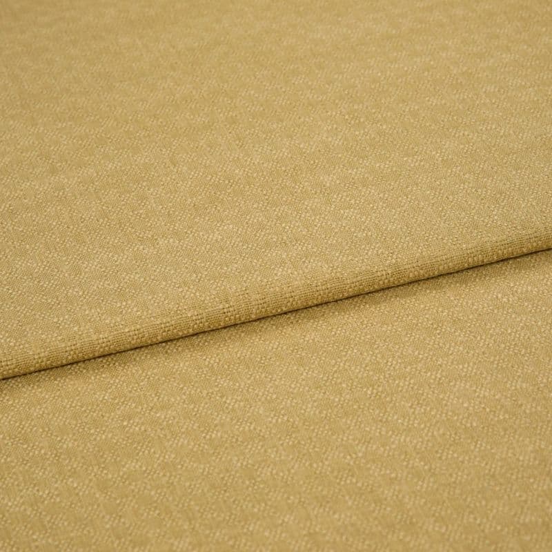 Beige woven fabric with fine pebble texture, folded once creating a horizontal overlap; close-up studio product shot with soft, even lighting showing fabric surface and seam detail.