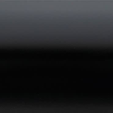 Glossy black panel with subtle horizontal bands, showing a smooth gradient from dark gray at top to deep black lower down; reflecting faint, diffuse light in a low-light, minimal setting.