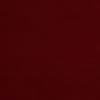 Solid burgundy fabric fills the frame, lying flat with subtle texture; evenly lit, featureless surface suggests a plain backdrop or sheet in low, diffuse light.
