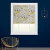A floral Roman blind with yellow, blue and beige blossoms covers a window, filtering daylight, in a navy-walled room with white frame, gold wire chair and circular wall candleholder.