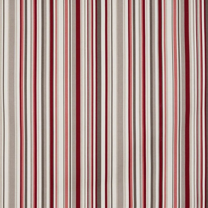Striped fabric curtain, vertically patterned with alternating red, burgundy, pink, beige, gray and white bands; hanging closed, smoothing toward floor; fills an interior wall with even, neutral lighting.