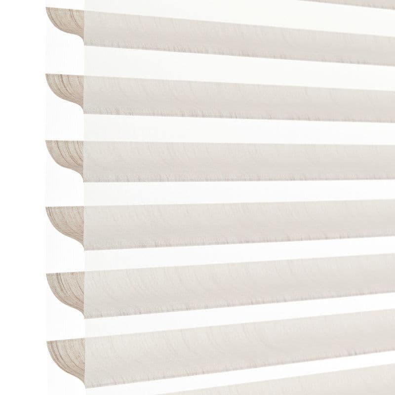 Sheer-and-opaque horizontal zebra blinds, lowered and aligned, alternating beige opaque and white translucent bands; filtering soft daylight in a bright, minimal close-up interior view.