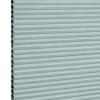 Light teal cellular (honeycomb) blind, fully lowered with visible hexagonal cells at left edge; horizontal pleats create uniform bands, blocking light in a close-up, evenly lit neutral background.