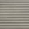 Horizontal pleated cellular blind, fully closed with evenly spaced fabric folds and subtle texture; blocking light and casting thin shadow lines; fills the frame in a neutral, softly lit interior.