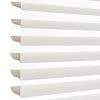 Sheer zebra roller blinds with alternating opaque and translucent horizontal bands, lowered to filter and diffuse bright daylight, shown close-up against a plain white background in soft light.