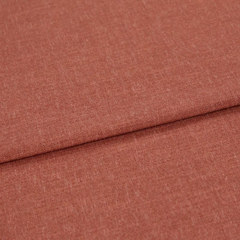 Woven terracotta textile, folded with an overlapping crease, displayed in a well-lit close-up emphasizing its fine, slightly heathered weave and flat, smooth surface.