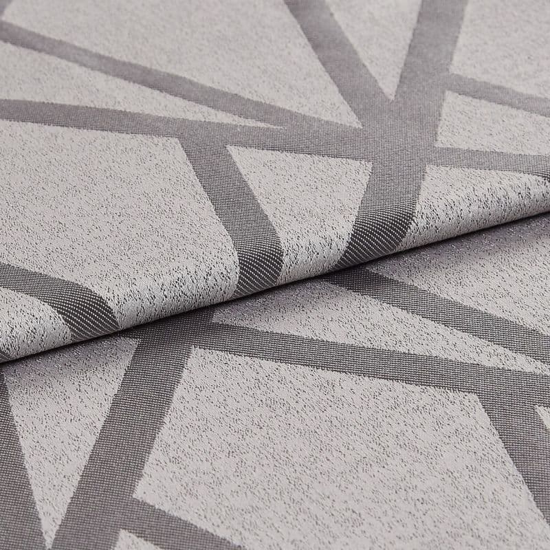 Textured light-grey fabric with dark-grey intersecting geometric bands (raised weave), folded once to reveal the edge; close-up studio-lit view highlighting weave, pattern and subtle sheen on a neutral surface.