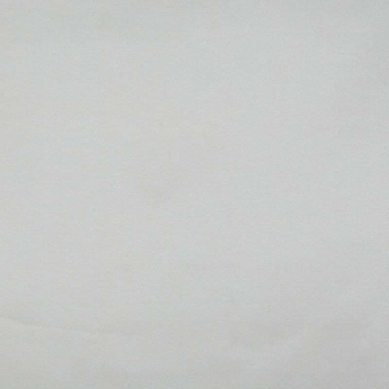 Light-gray fabric curtain, fully drawn and smoothed with a subtle horizontal crease; filtering soft diffuse light, filling a neutral indoor wall or window area with even, muted illumination.