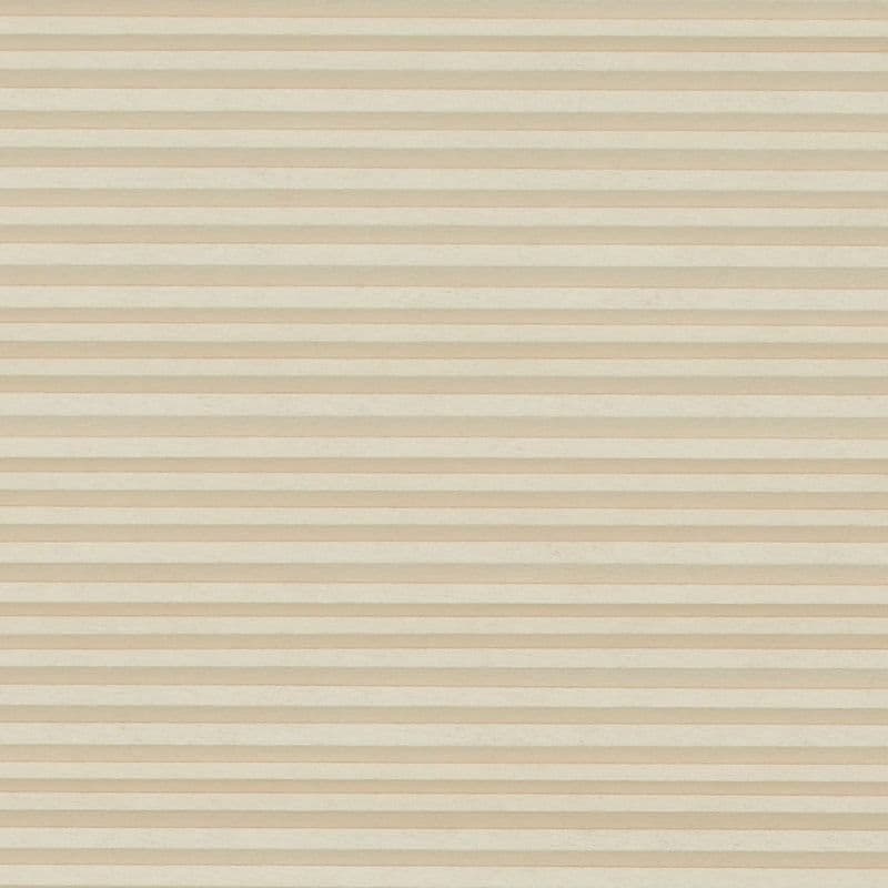 Beige cellular (honeycomb) blind with narrow horizontal pleats, fully lowered and closed, softly filtering light across an undecorated neutral interior with no visible window or outside view.