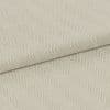 Cream herringbone-woven fabric folded diagonally, showing raised ribbed chevron pattern; laid flat under soft, even lighting for a close-up textile detail.