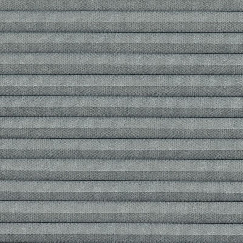 Gray pleated cellular window shade with horizontal accordion folds, fully lowered and closed, textured fabric and uniform spacing; close-up view filling frame under soft, diffuse lighting.