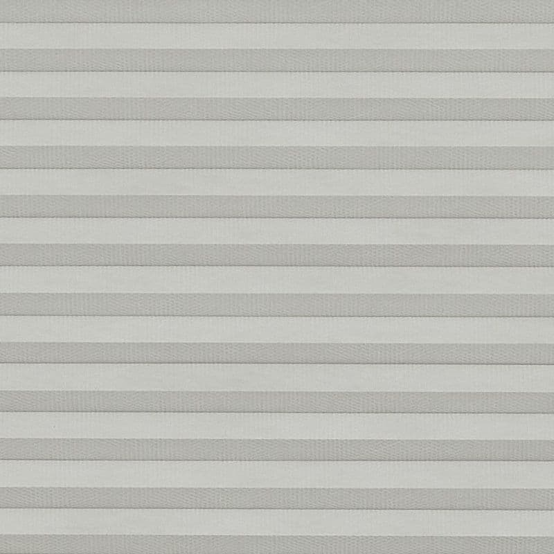 Light-gray pleated cellular blinds, lowered and fully closed, diffusing soft daylight; covering a window in a neutral, evenly lit interior with no outside view visible.