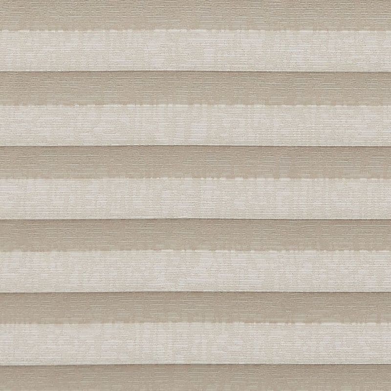 Pleated double-layered cellular shades, horizontal beige and ivory bands, lowered and closed, softly diffusing light; close-up view showing textured fabric panels across a neutral interior setting.