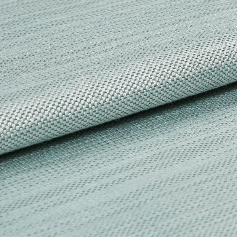 Light blue woven fabric with tight basketweave texture, folded across the frame creating an overlapping edge; close-up studio shot with soft, even lighting and shallow depth of field.