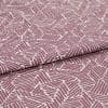 Folded printed cotton fabric with mauve geometric stripe blocks, repeating irregular parallelograms; folded edge runs diagonally, fabric lies flat under soft studio lighting for a close-up textile view.