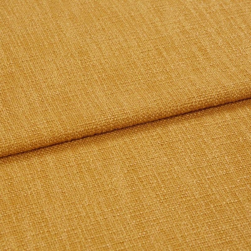 Coarse mustard-yellow woven fabric, folded with a horizontal overlap, showcasing tight textured weave and subtle sheen; close-up under soft, even lighting.