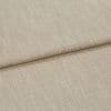 Beige woven fabric folded into overlapping panels, showing coarse textured upholstery weave; a horizontal fold/edge across frame, close-up studio-lit view suggesting a sofa cushion or fabric sample.
