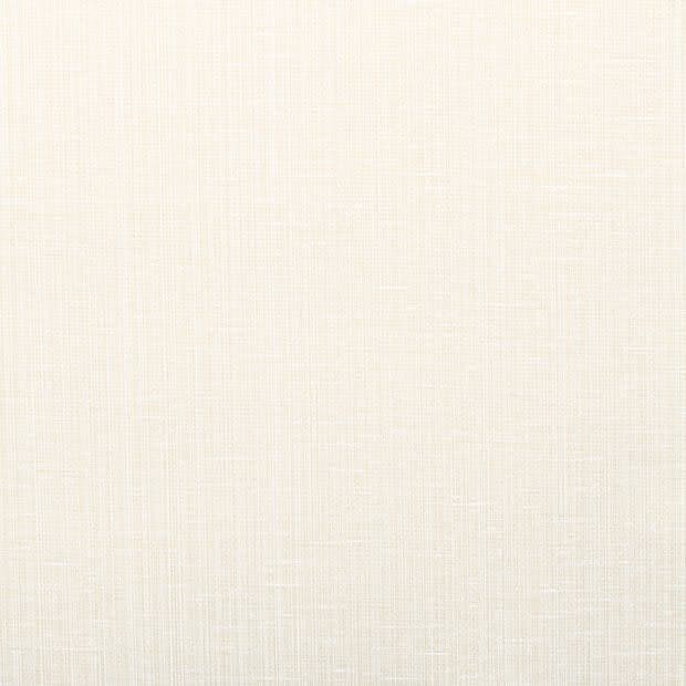 Cream-colored woven linen fabric (wallpaper or upholstery) occupying the frame, showing fine crosshatch texture; lying flat and evenly lit, serving as a neutral background with soft, warm lighting.