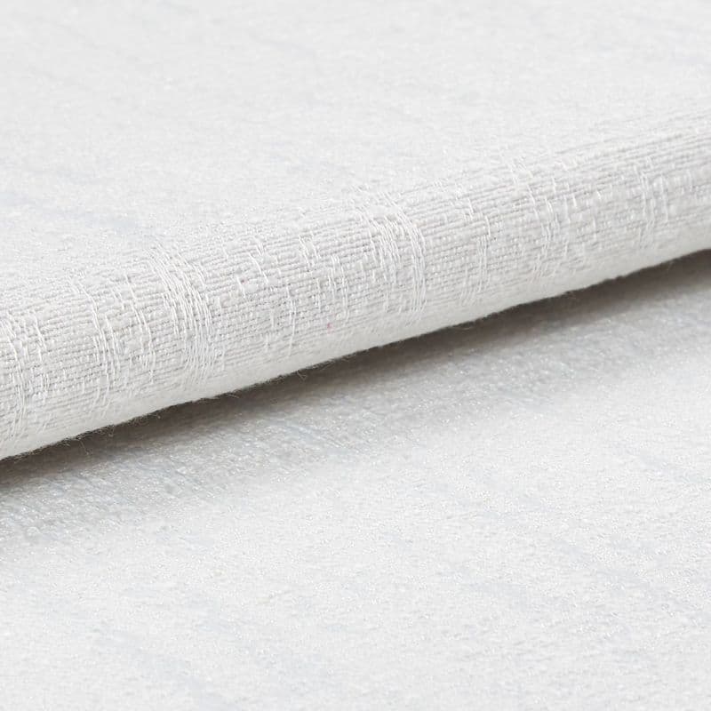 White textured fabric roll with coarse woven pattern; layered and slightly folded, resting overlapped on a matching textured surface in bright, diffuse studio lighting, close-up detail.