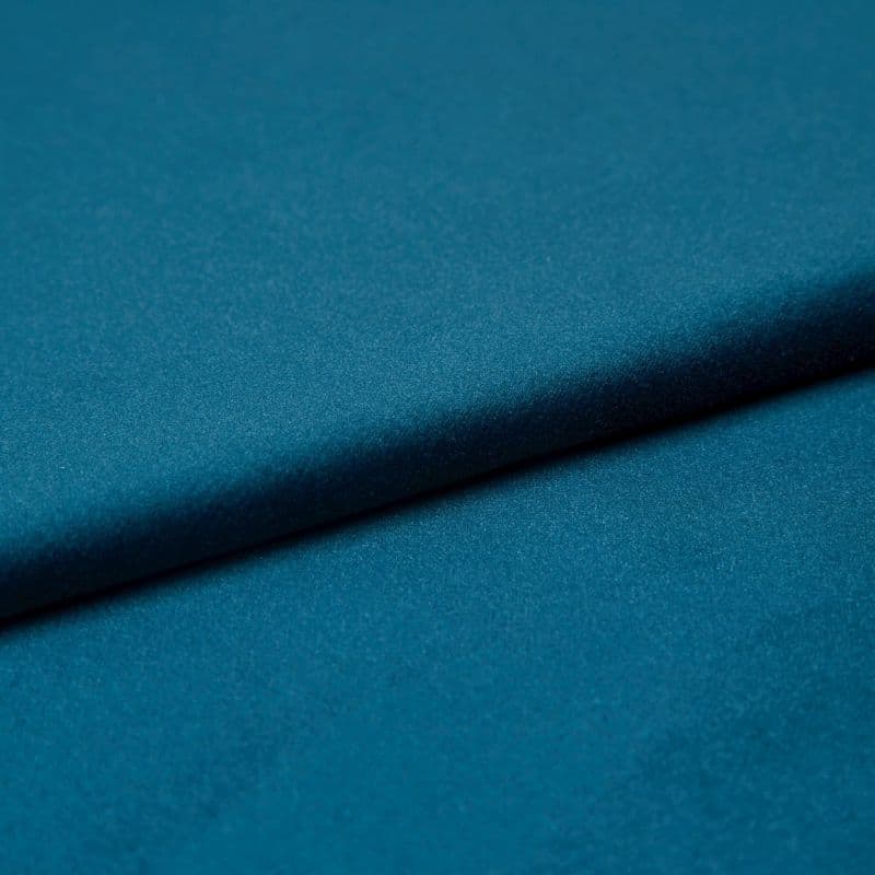Teal satin fabric, folded diagonally with a soft sheen and subtle texture; fold casting a gentle shadow, close-up studio view with even lighting emphasizing the smooth surface.