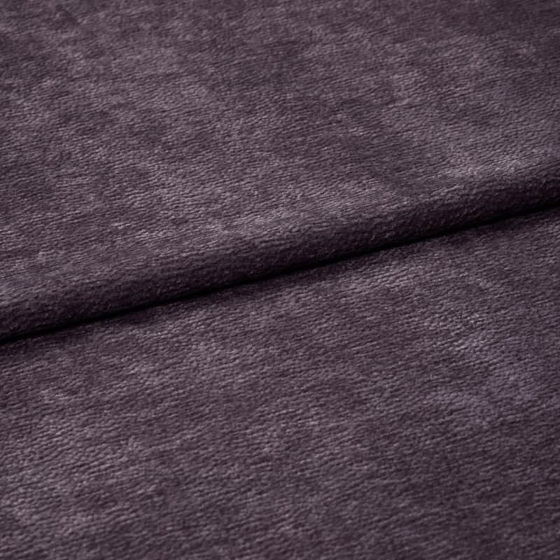 Plush purple velvet fabric with soft fine nap, horizontally folded near center and overlapping itself; close-up studio view emphasizing texture and subtle sheen under diffuse lighting.