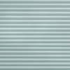 Light-teal pleated cellular blinds covering entire frame, horizontal narrow folds and textured fabric; closed, evenly filtering diffuse cool light; minimal interior context, no visible window or furnishings.