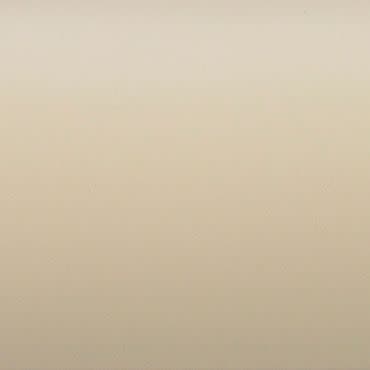Smooth beige wall covering the entire frame, showing subtle texture and faint gradient, illuminated by soft even ambient light with no visible fixtures or furnishings.