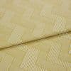 Folded mustard-yellow woven fabric with white narrow-striped, interlocking rectangular (herringbone-like) pattern — folded once — shown close-up on a flat surface under soft, neutral studio lighting.