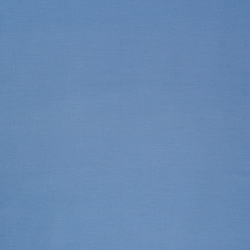 Light-blue woven roller blind, fully lowered and smooth, filtering soft diffuse daylight and obscuring the window; surrounding interior minimally visible with even, muted lighting.